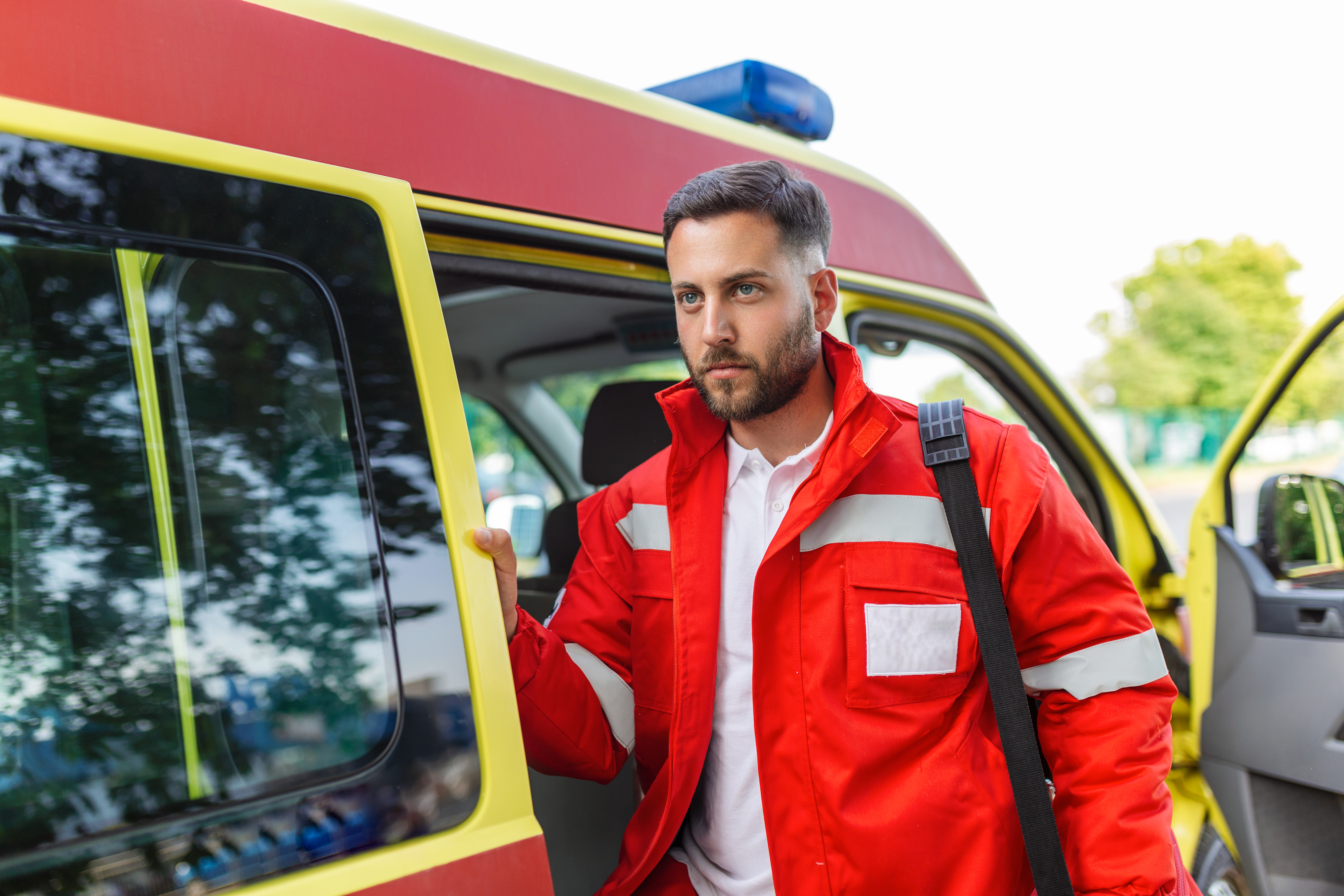 ambulance-staff-member-emerges-from-back-ambulance-with-his-emergency-backpack-vital-signs-monitor